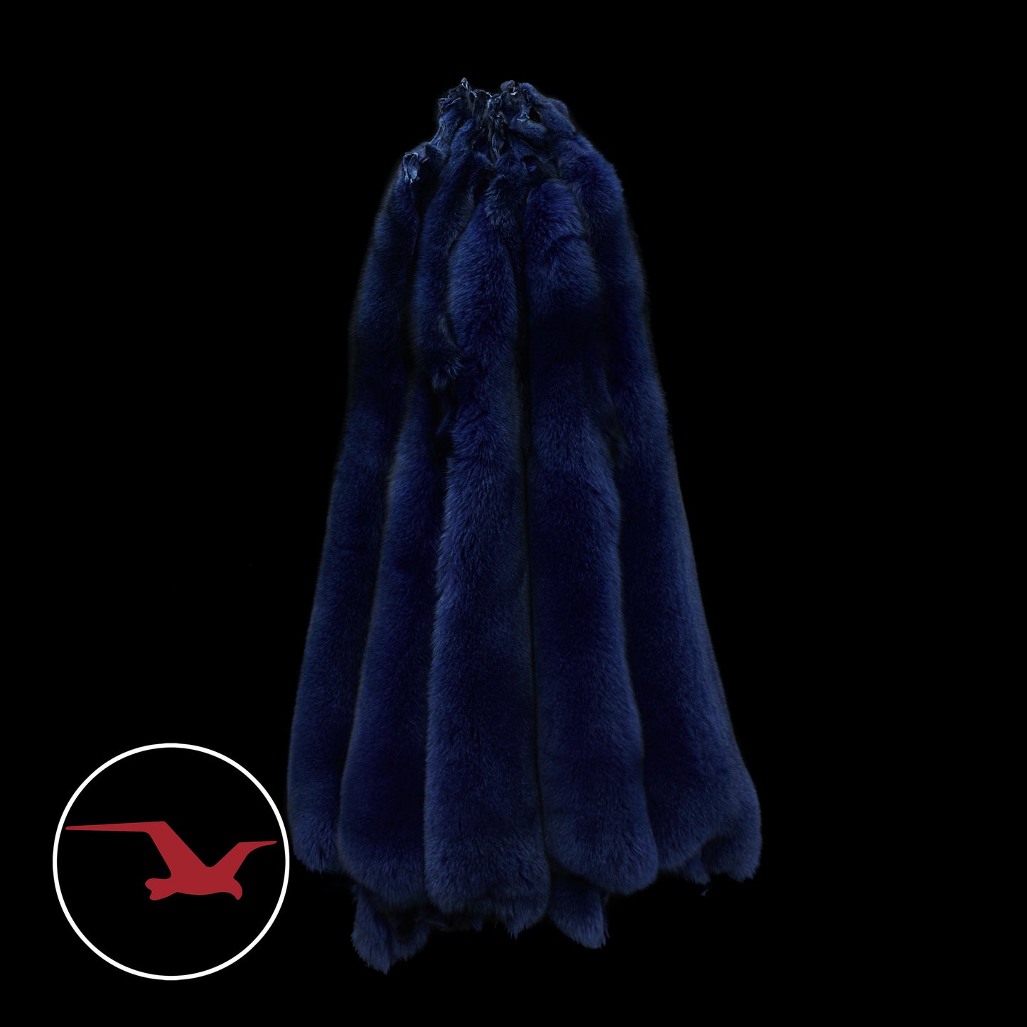 A dyed Norwegian blue fox fur in a dark setting, likely intended as an accessory for a winter parka.