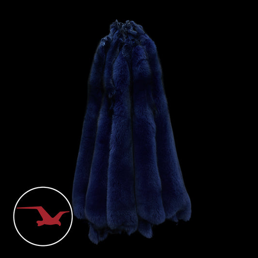 A dyed Norwegian blue fox fur in a dark setting, likely intended as an accessory for a winter parka.