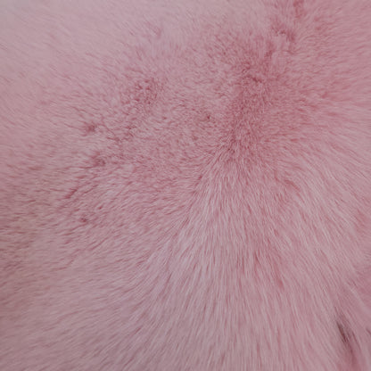Close-up image of dyed shadow faux fur in baby pink, showing its texture and softness.