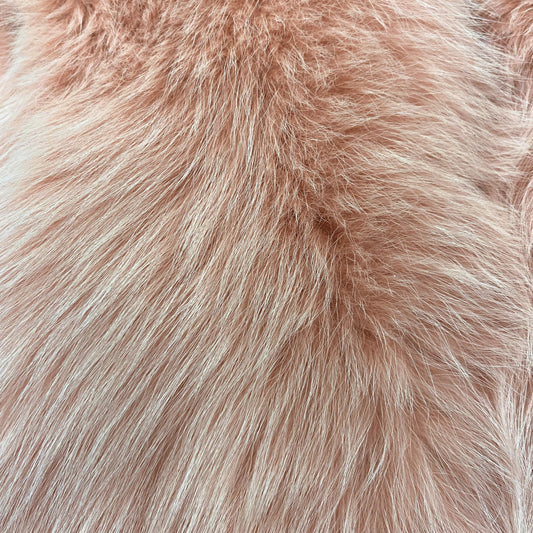 Close-up of peach-colored dyed shadow fox fur fabric